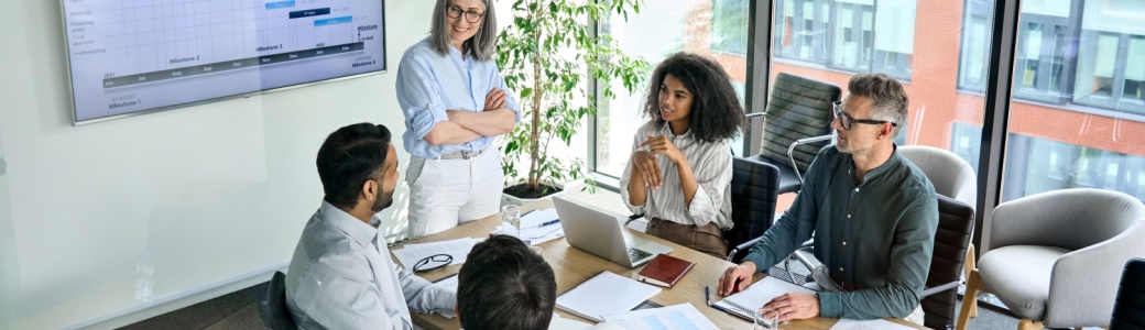 A woman presenting to her colleagues.