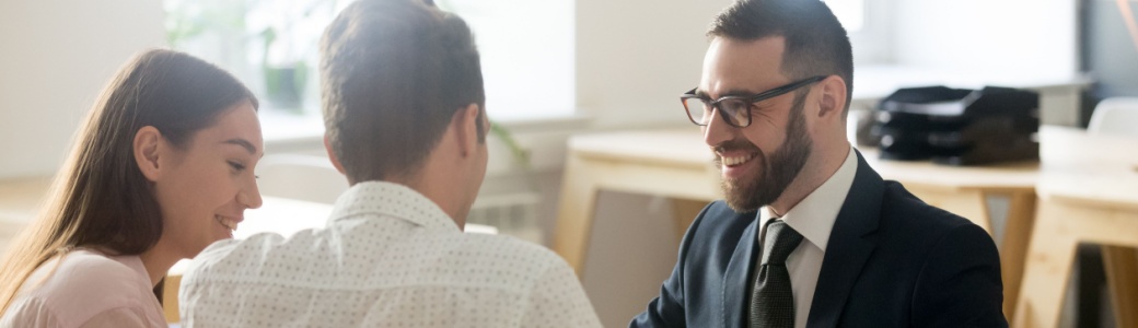 A young couple meeting with a financial planner.