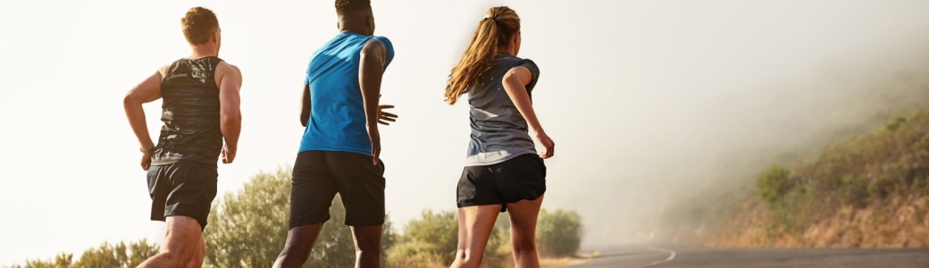 Three people running outdoors.