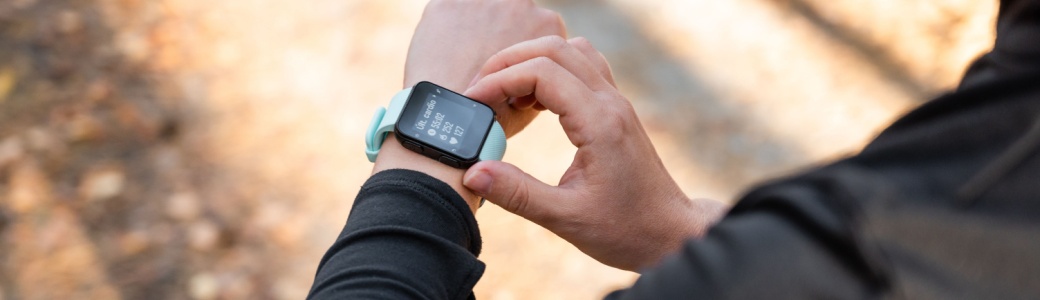 A runner looking at the time on their watch.