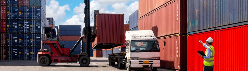 A foreman organising containers from a cargo ship.