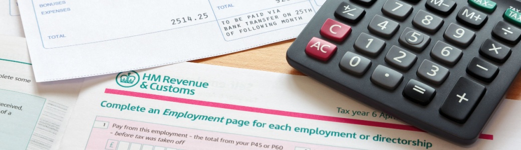 Paperwork relating to a tax return, with calculator and pen lying on it