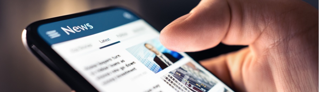 A person looking at a news feed on their phone.