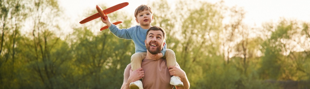 A father with a child sitting on his shoulders.