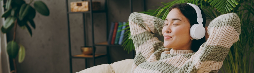 A woman relaxing with headphones on.
